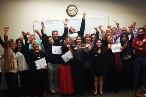 Melina Sardar celebrating with a leadership workshop group