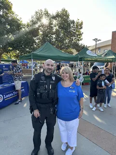Melina Sardar with a police officer at a community event