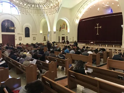 Melina Sardar speaking to a large community audience